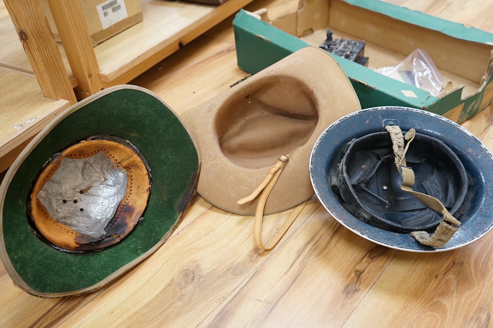 A collection of military related items, including an instrument panel from a WWII RAF Lancaster bomber aircraft, a Bosun’s whistle, a Heckler and Koch ‘bullet’ pen, a WWII tin hat (possibly police), a pith helmet, an Aus